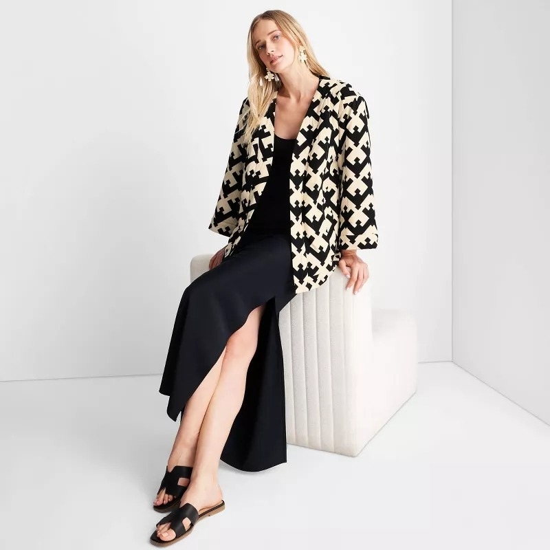 A model wears the black and white geometric print quilted coat
