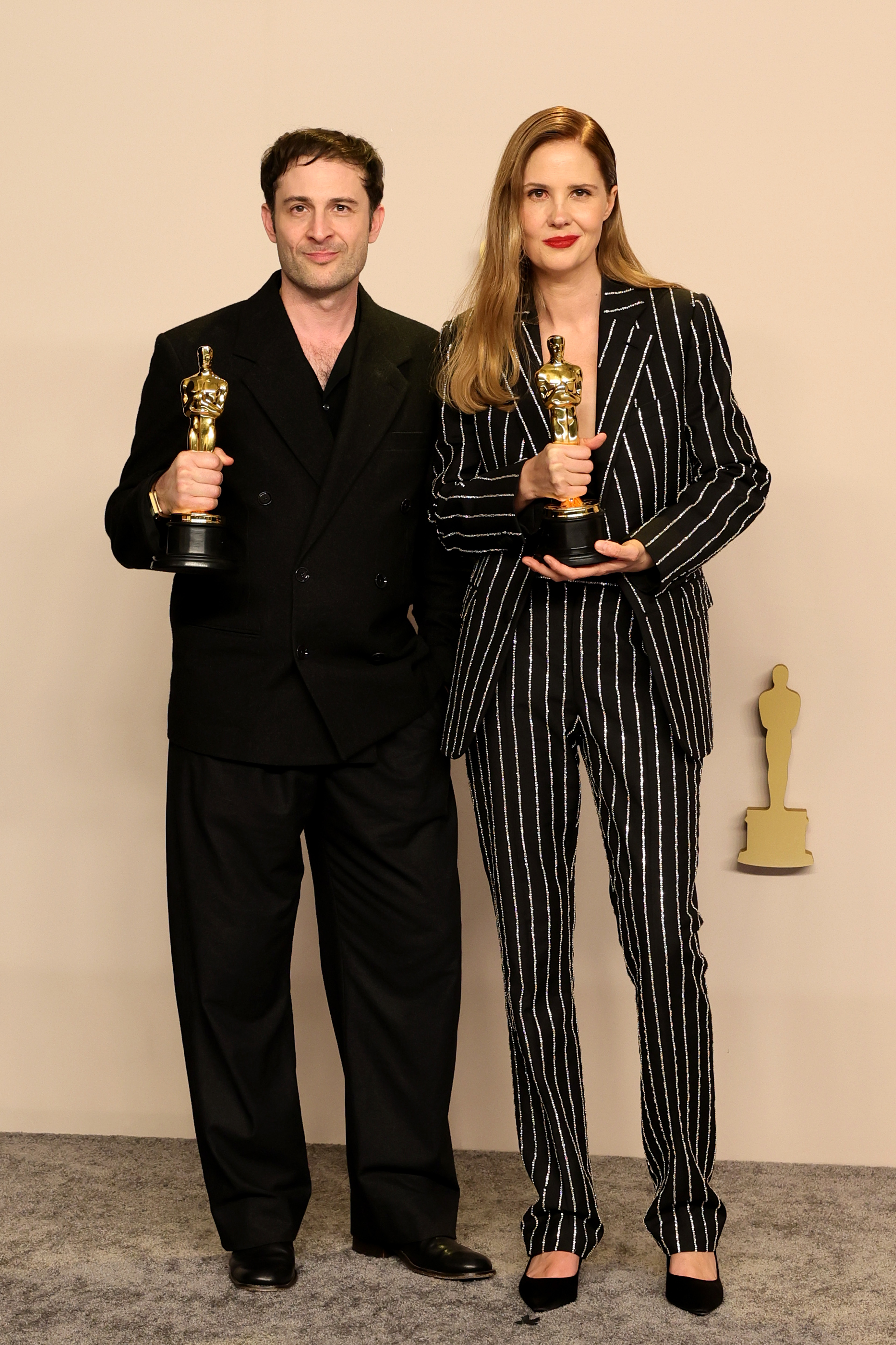 Arthur Harari and Justine Triet with their Oscars