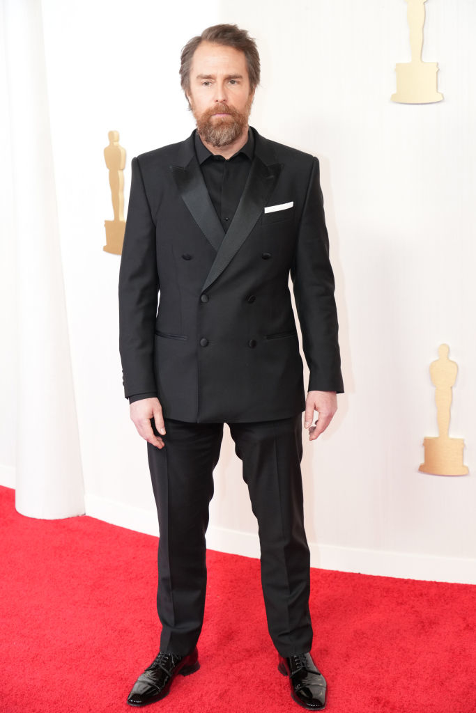 Sam Rockwell in a tailored black suit with a diagonal buttoned blazer on the red carpet