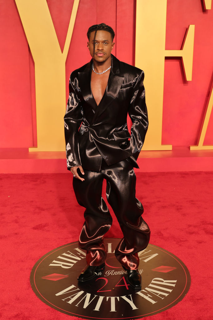 Jeremy in a baggy satin suit posing on the red carpet