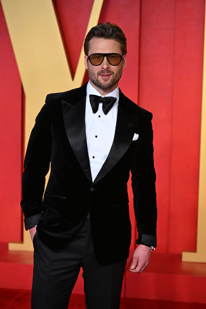 Glen in sunglasses and black tuxedo with bow tie on red carpet