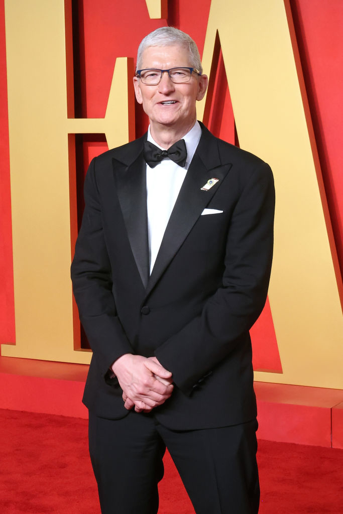 Tim in a classic tuxedo with a bow tie and lapel pin