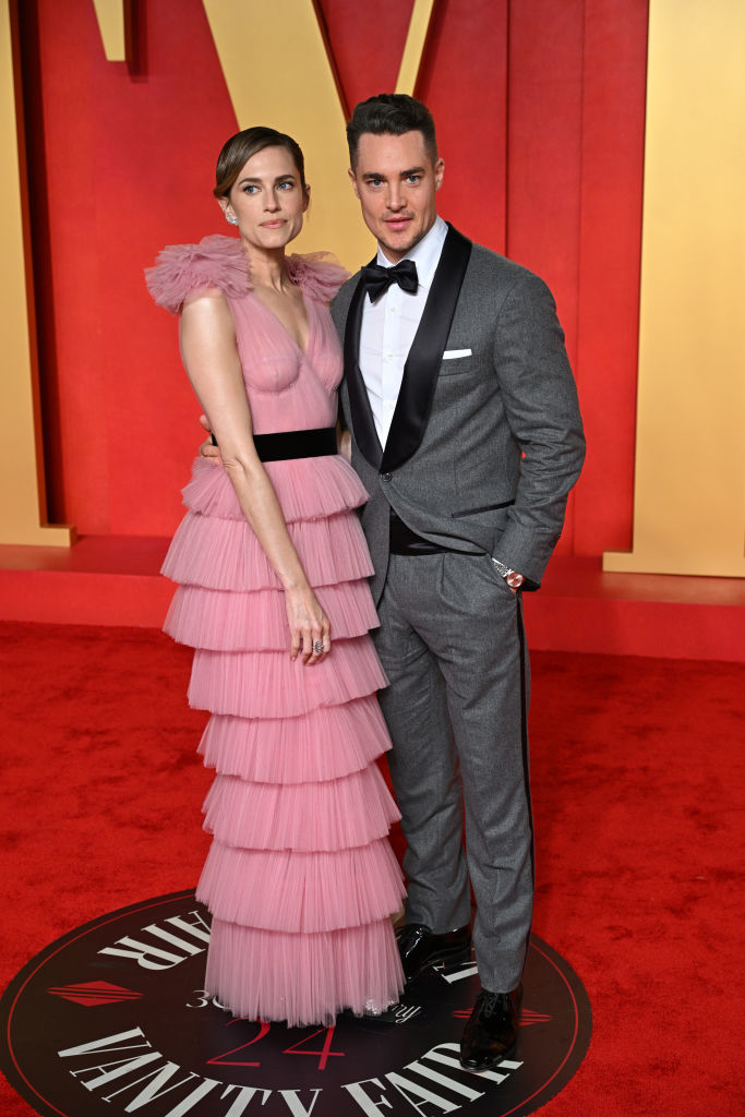 Allison in a layered ruffled sleeveless dress and Alexander in a gray suit with a bow tie