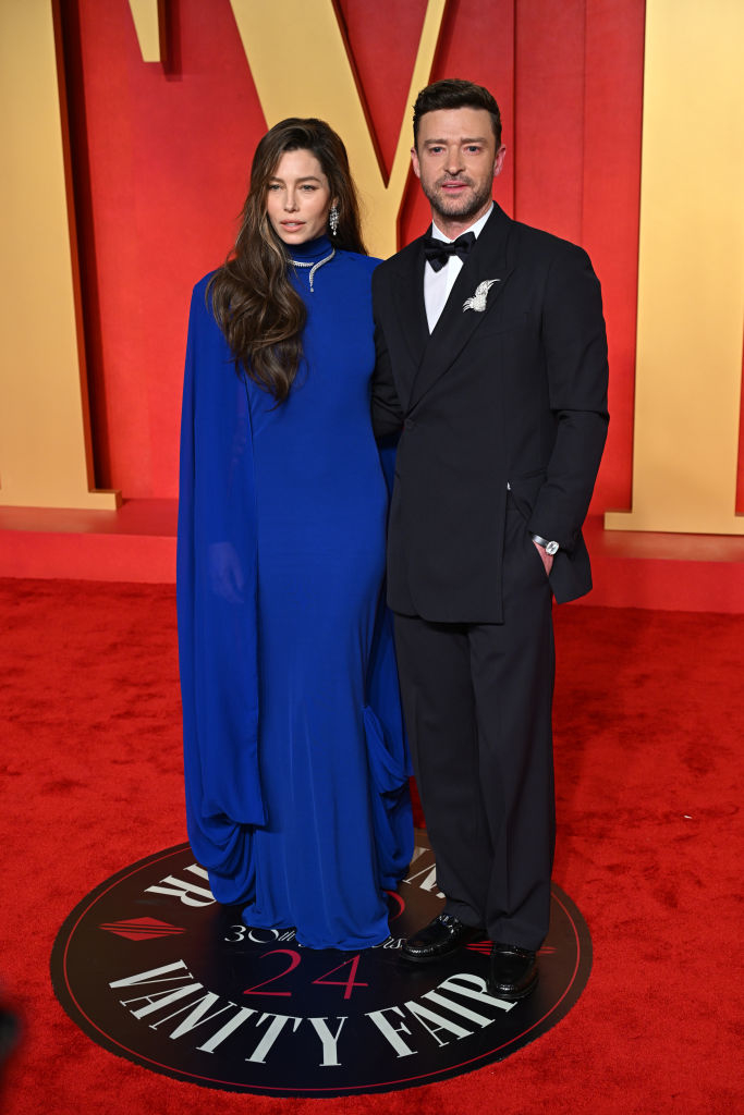 Jessica in a blue evening gown with a cape, Justin in a black suit and bow tie