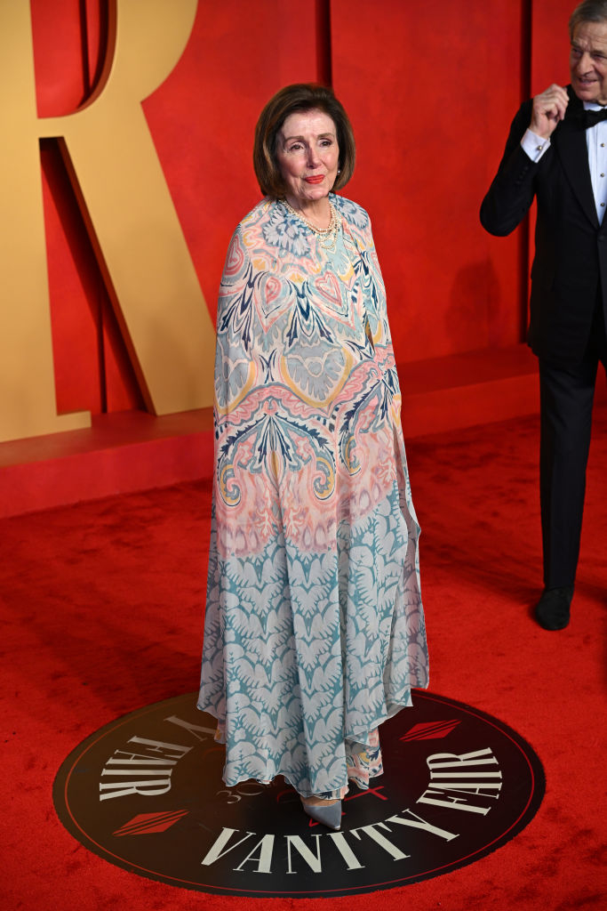 Nancy in a patterned cape gown at Vanity Fair event
