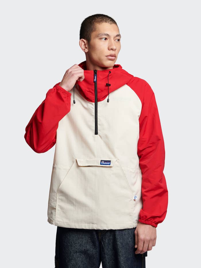 Person in a half-zip hooded pullover with large front pocket, styled for a modern, casual look