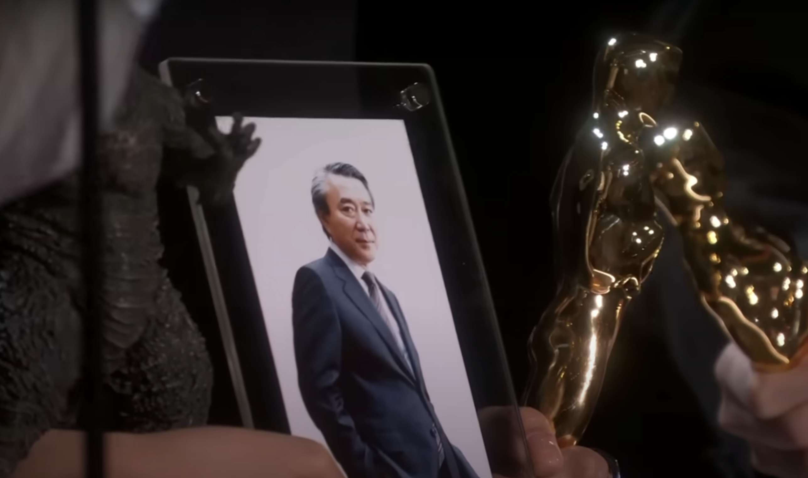 A framed photo of Shuji Abe held onstage at the Oscars