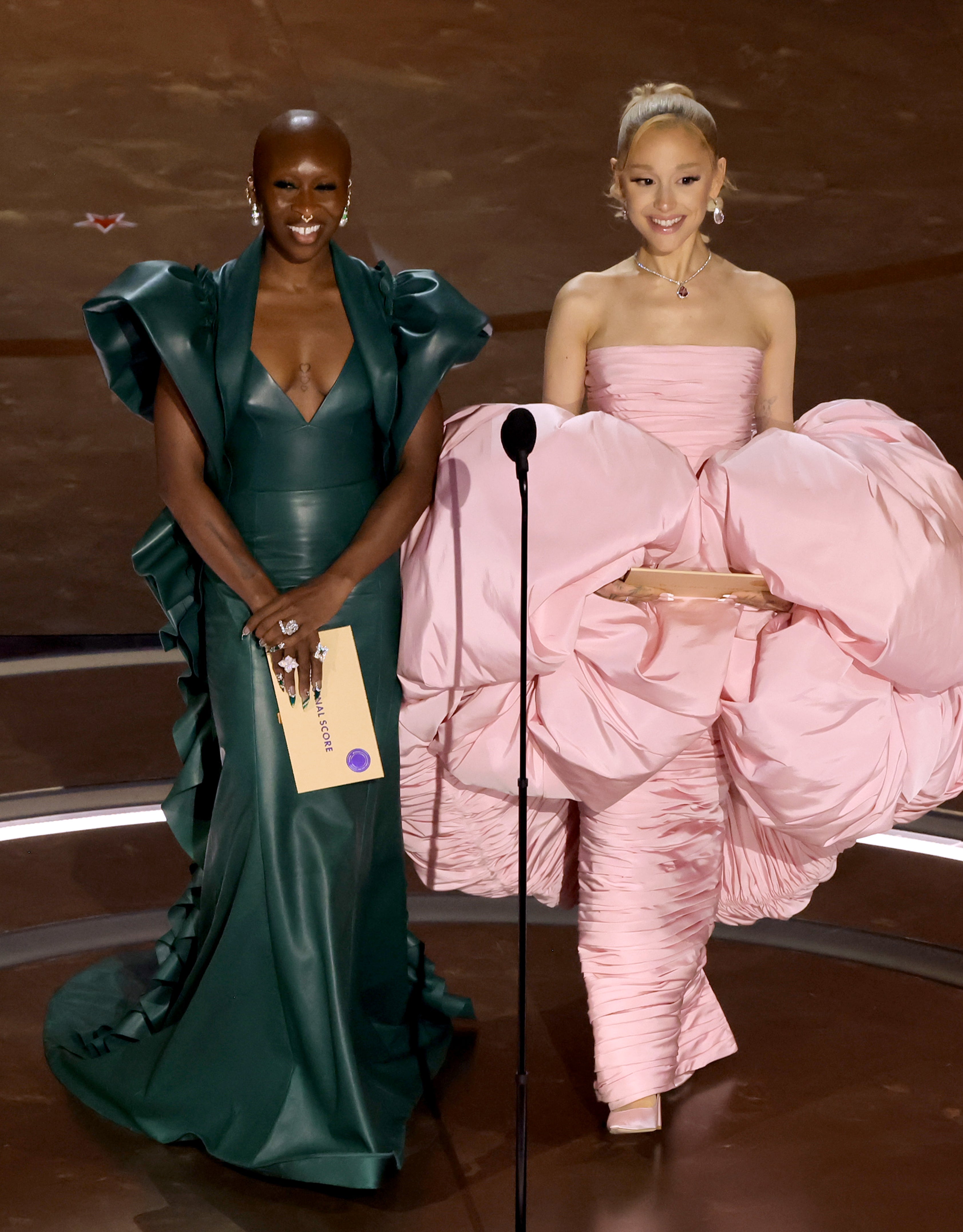 Cynthia Erivo and Ariana Grande onstage at the Oscars presenting an award