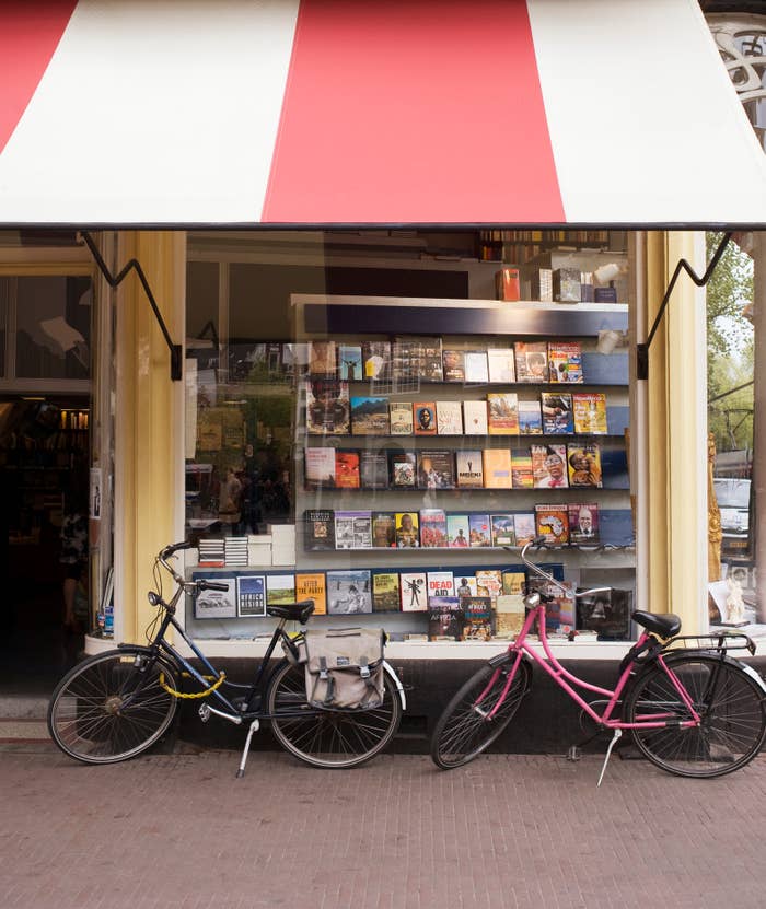Bookstore exterior with a display of books in the window and two bicycles parked in front