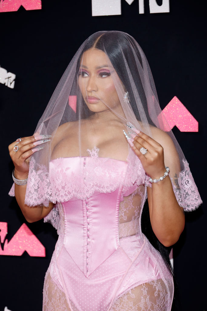 Nicki Minaj in a pink corseted dress with a lacy white veil at an MTV event