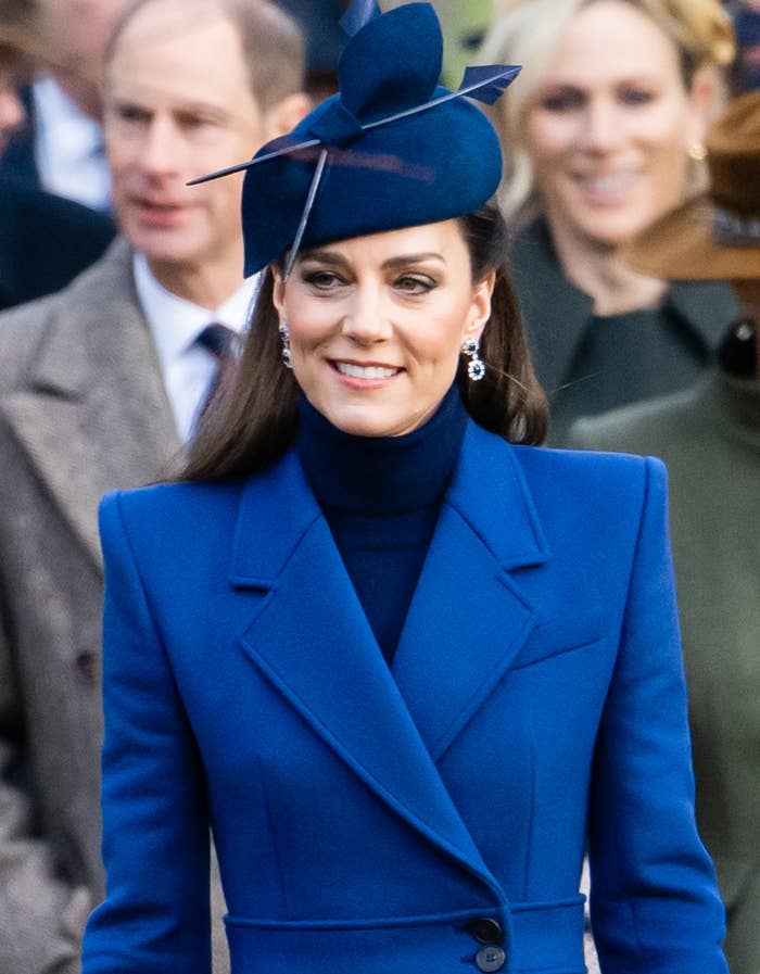 Kate in a blue jacket and matching hat with a bow