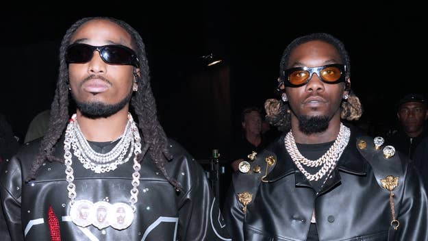 Two men in leather jackets with metallic adornments and sunglasses, wearing layered necklaces