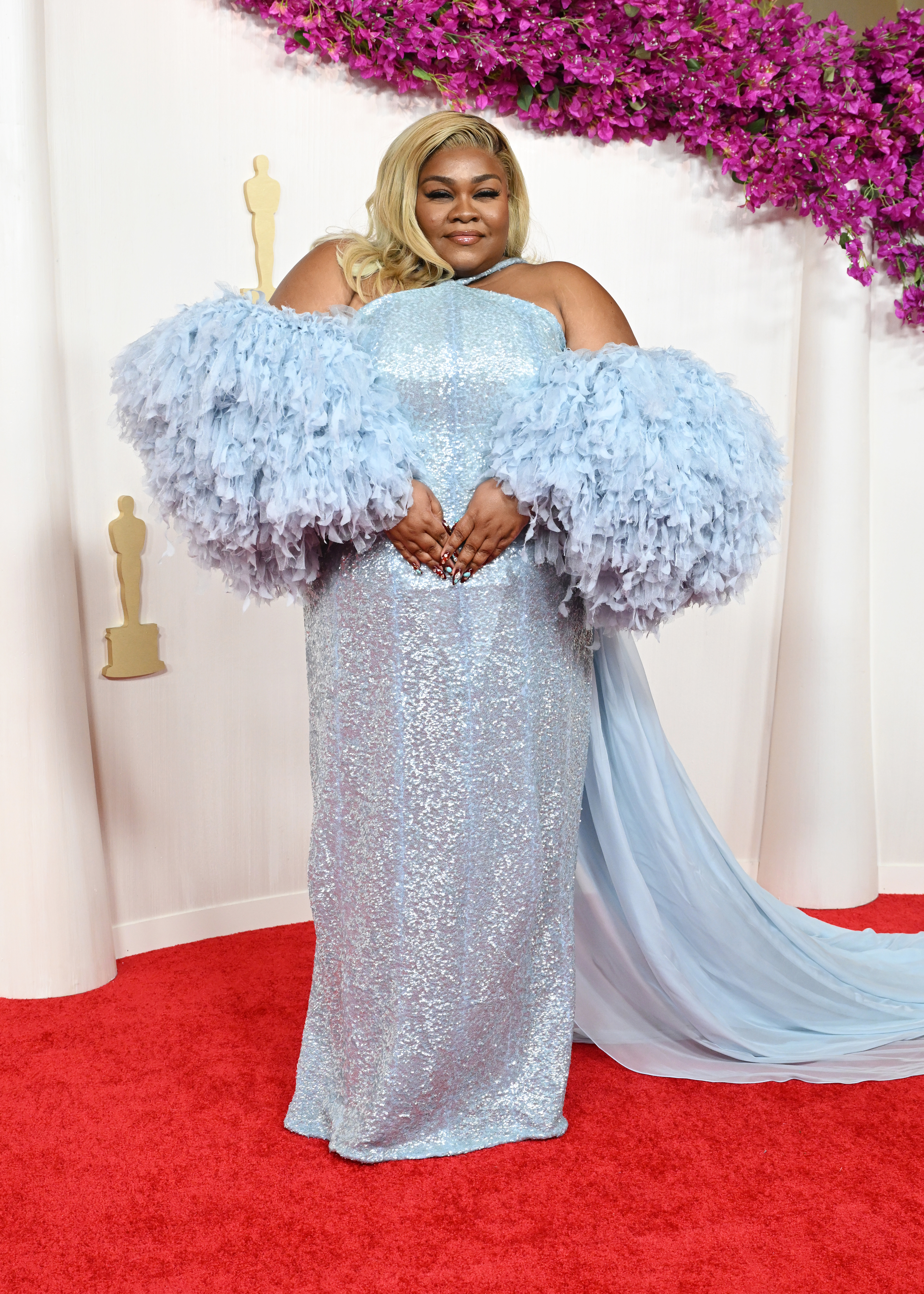 Da’Vine in a sequined gown with tulle sleeves on the red carpet