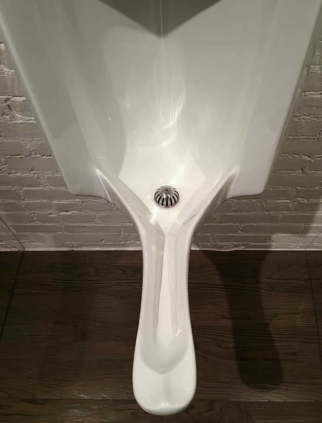Urinal with a tubular protuberance extending from the center