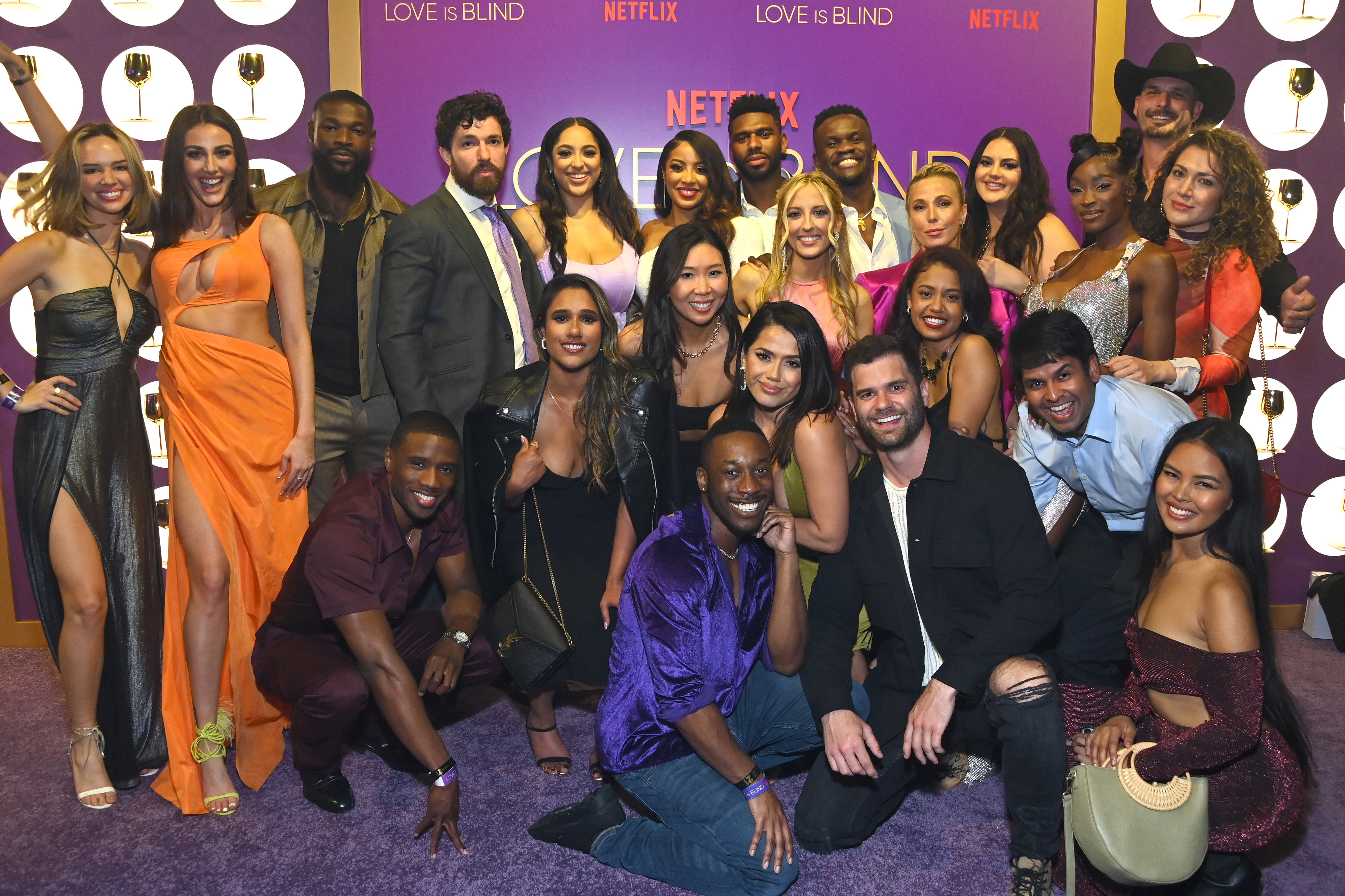 Group of &quot;Love is Blind&quot; reality show cast members posing together at a Netflix event