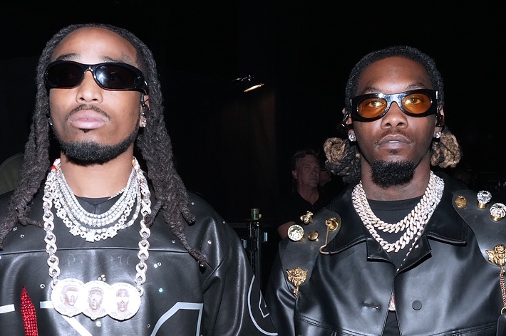 Two individuals in black jackets with chains; style relevant to a music article