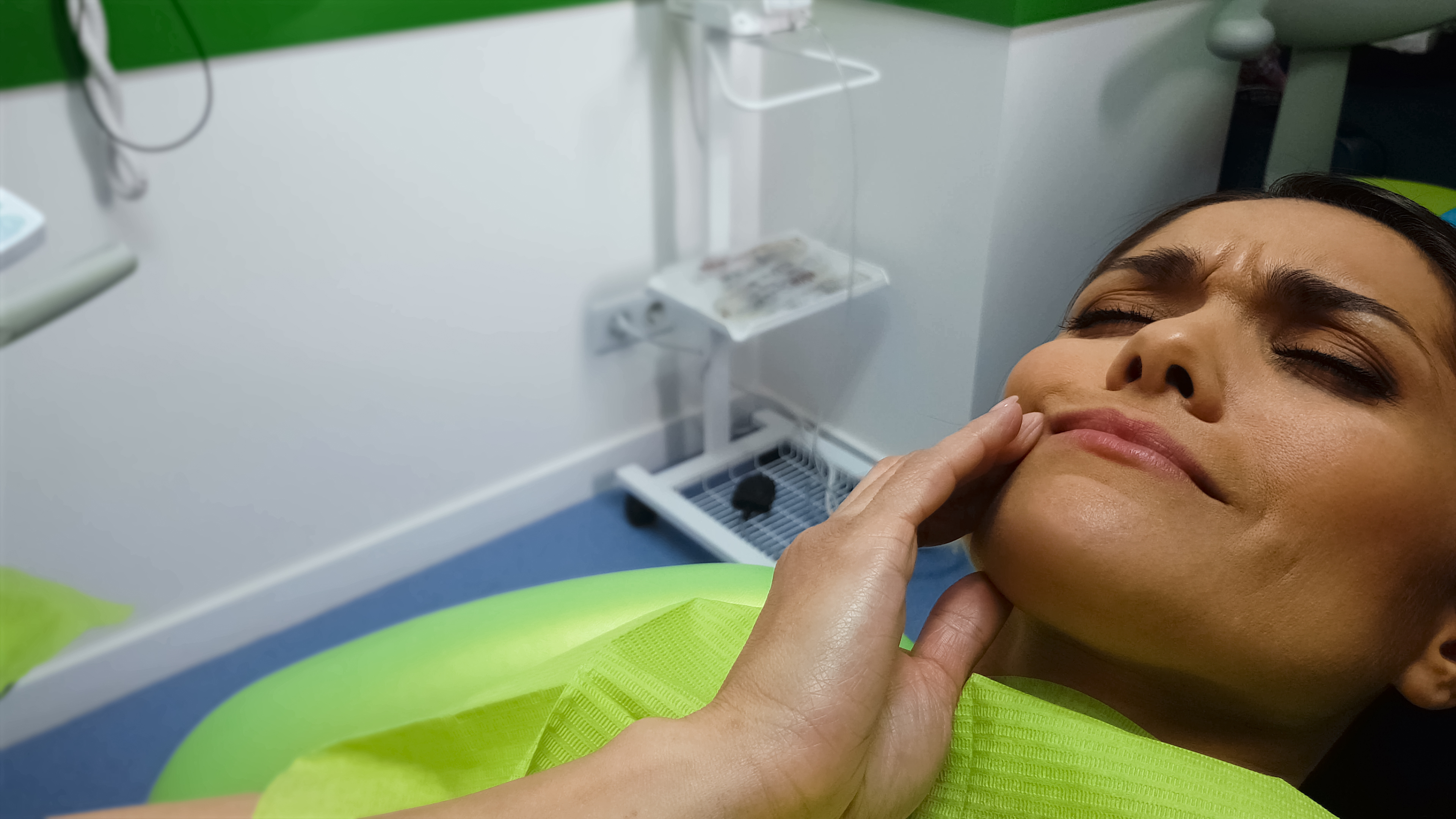 Woman receiving a facial treatment at a spa, looking relaxed