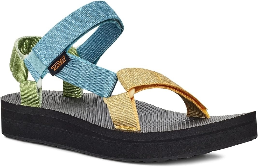 A sandal with multicolored straps and a thick black sole