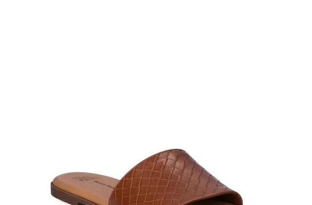 A brown, crocodile-embossed slide sandal displayed against a white background