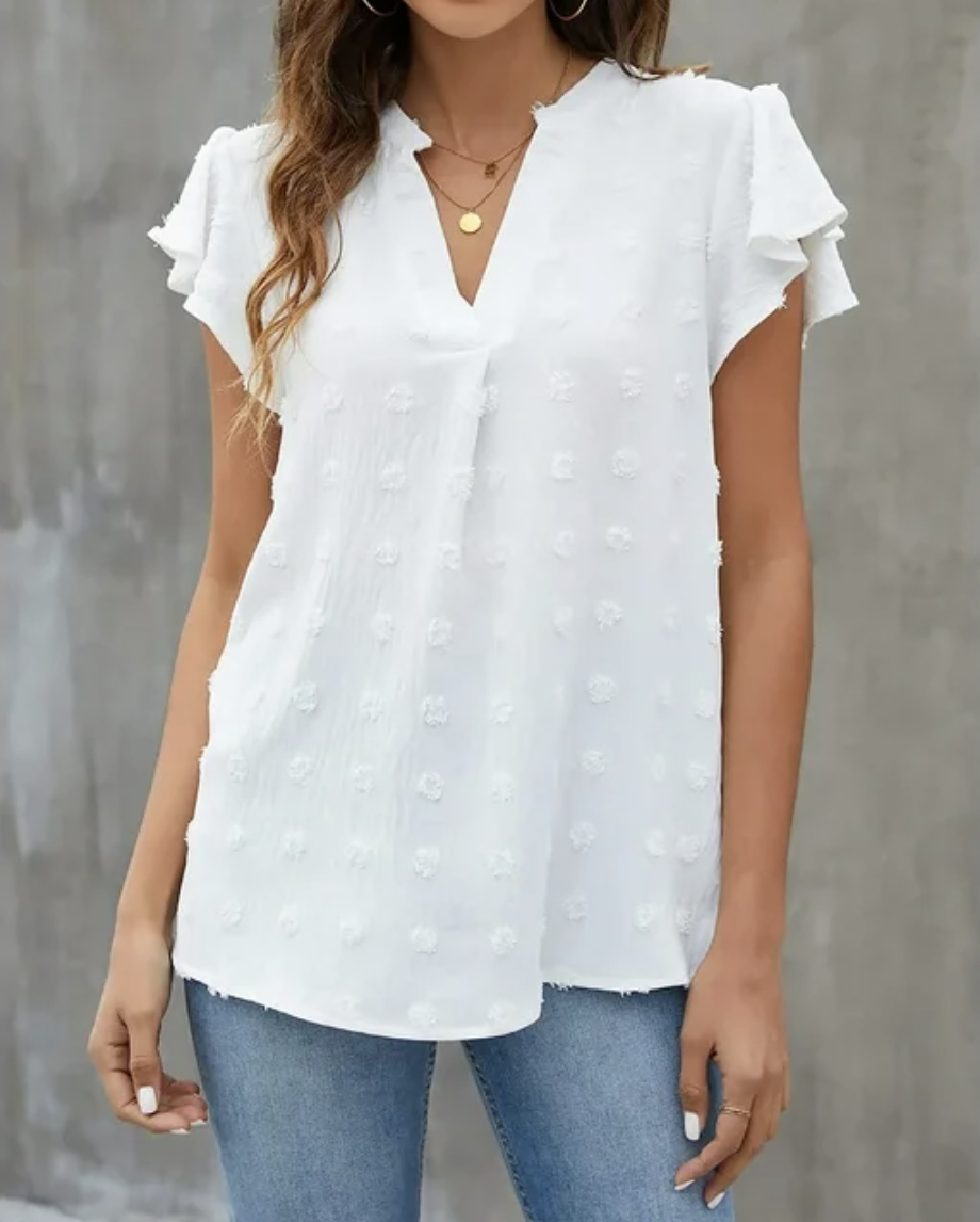A white textured blouse with ruffle short sleeves