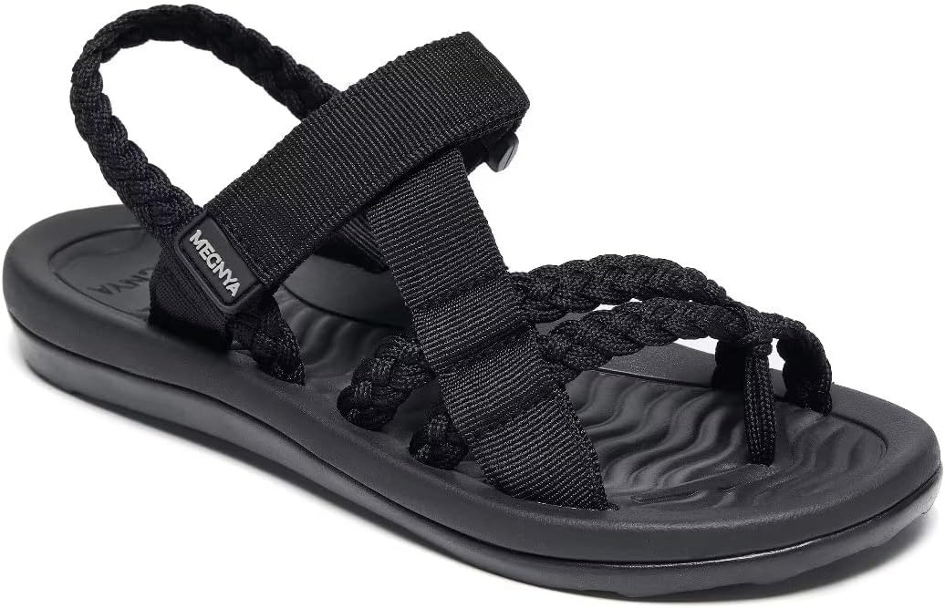 Black strappy sandal with a textured footbed and logo on the strap