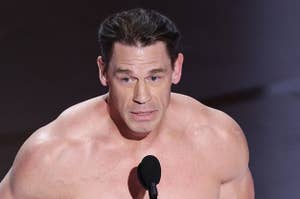 John Cena wearing a small costume piece, presenting at an event