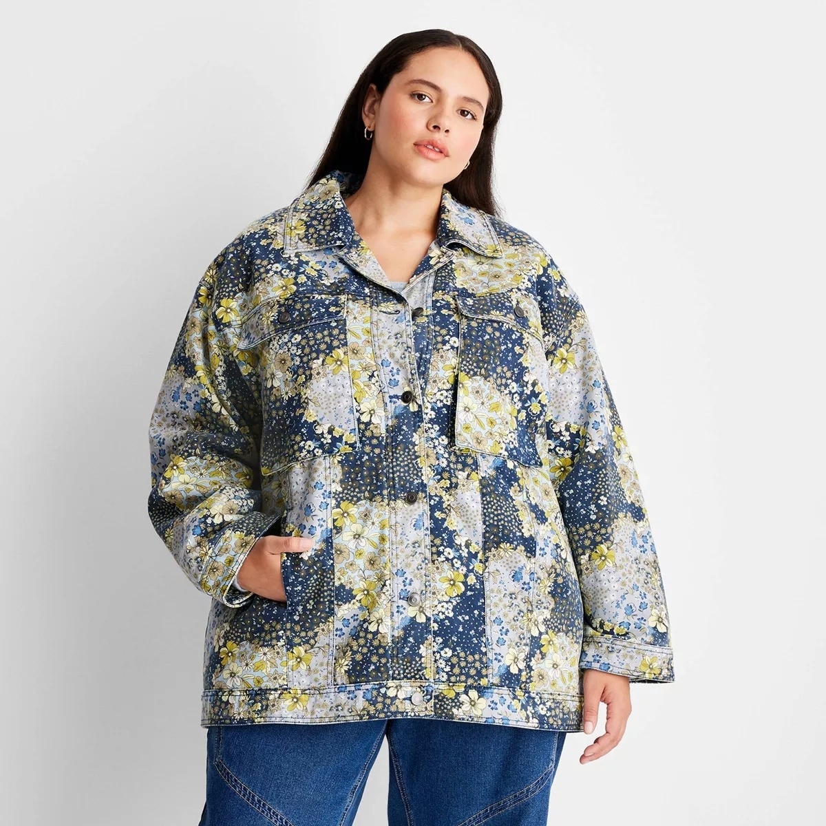 Model wearing a floral print denim jacket