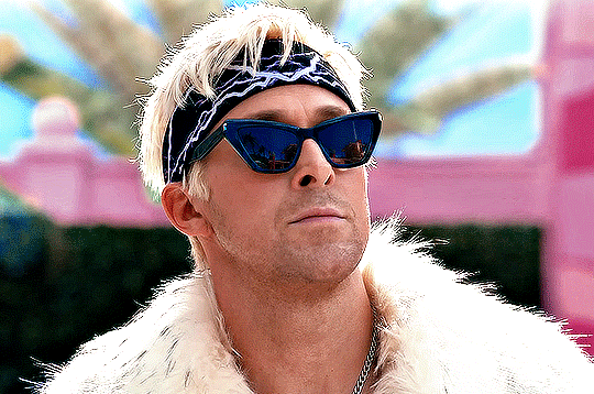 Man wearing sunglasses, headscarf, and fur coat