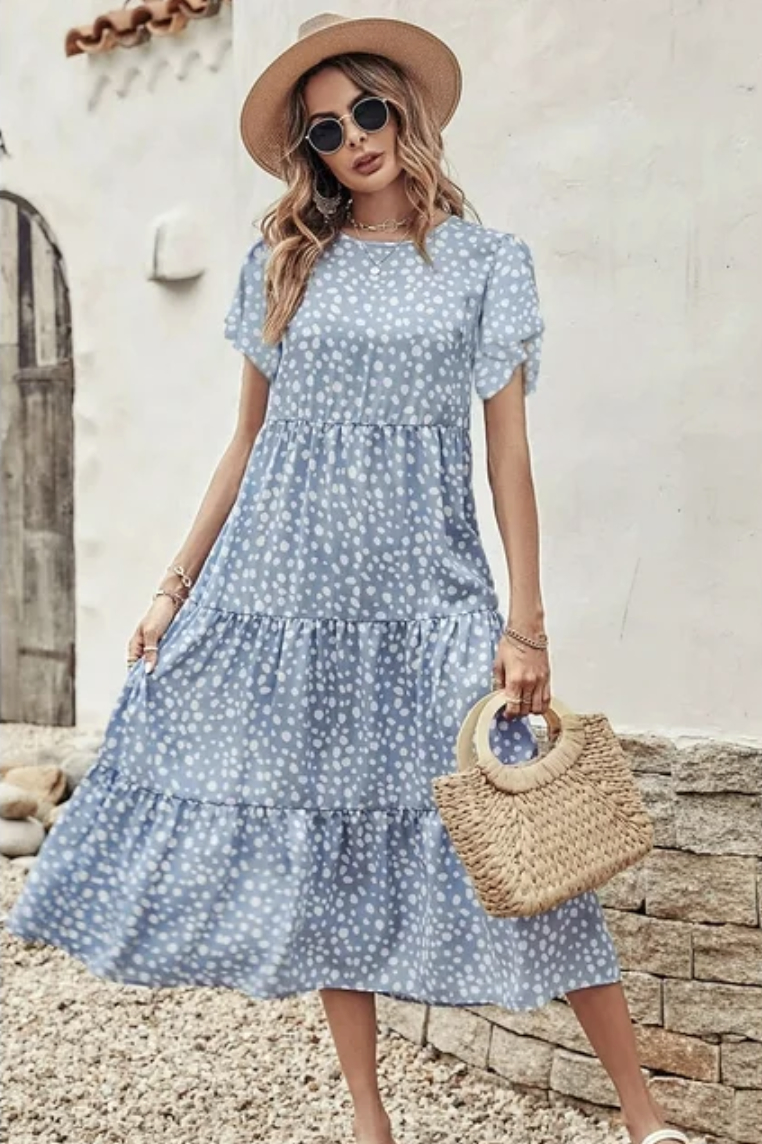 Model in a blue and white dot midi dress with puff sleeves