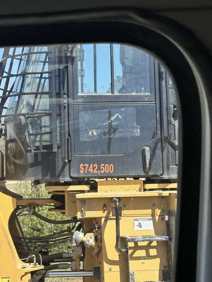 Price tag of $742,500 displayed on a construction vehicle&#x27;s window