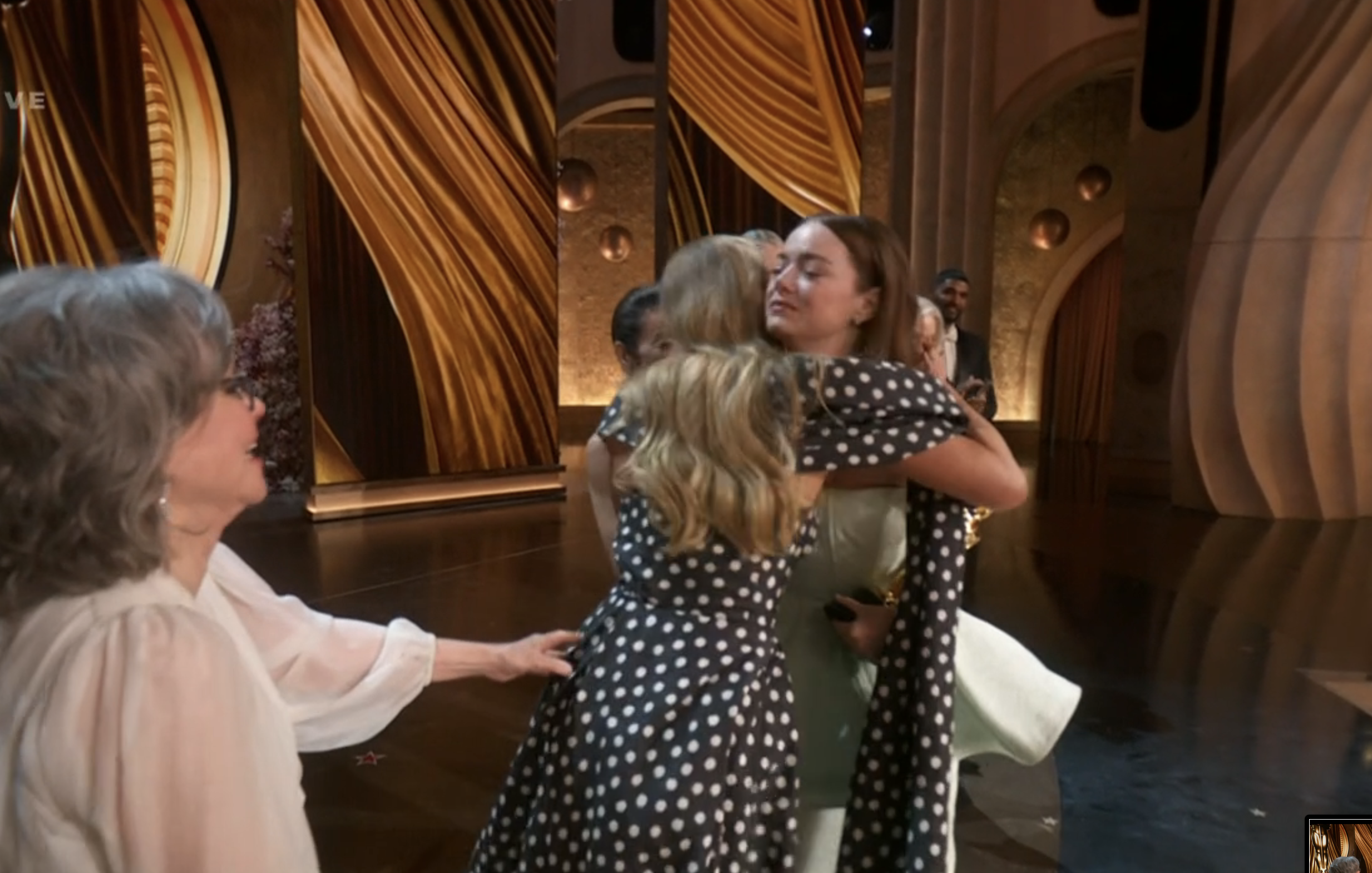 Jennifer and Emma hugging on stage
