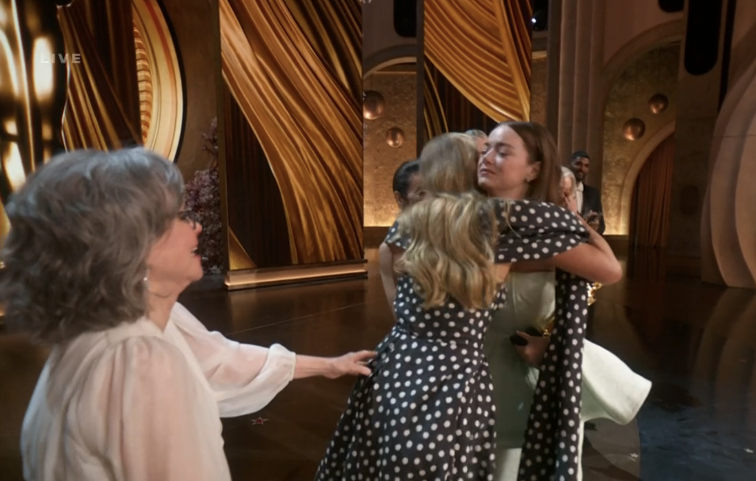 Jennifer and Emma hugging on stage