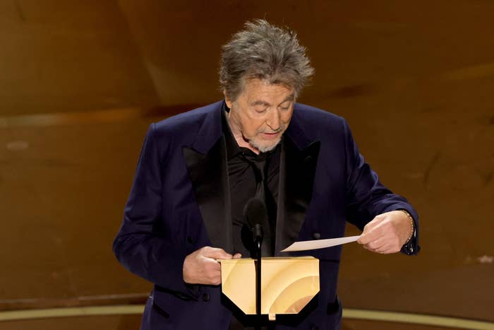 Al on stage reading the envelope