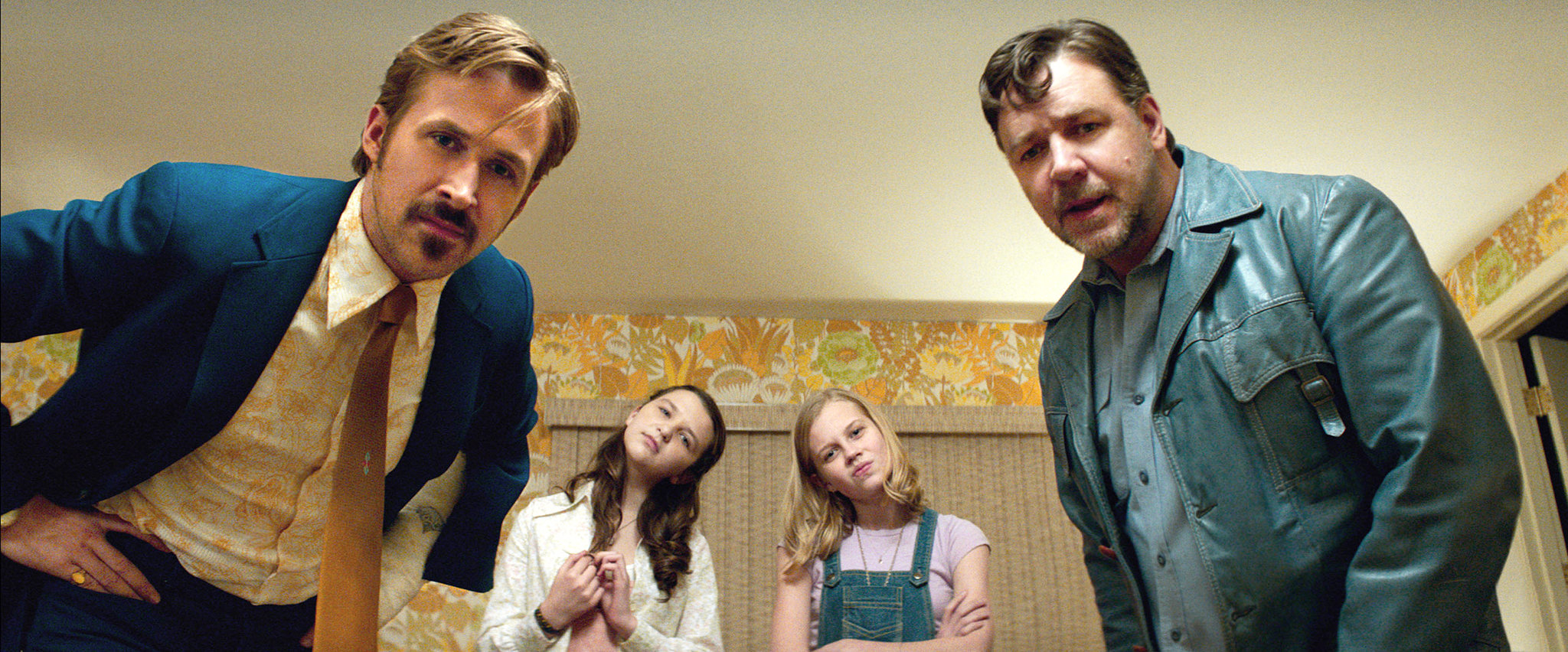 Four people posing dramatically in a vintage-style room from the movie &quot;The Nice Guys.&quot;