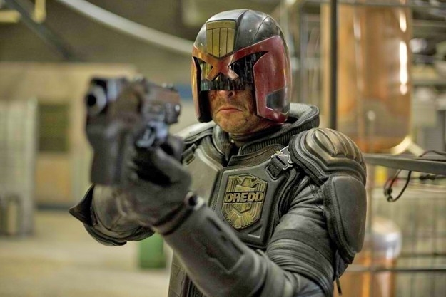 Character Judge Dredd in costume aiming a gun