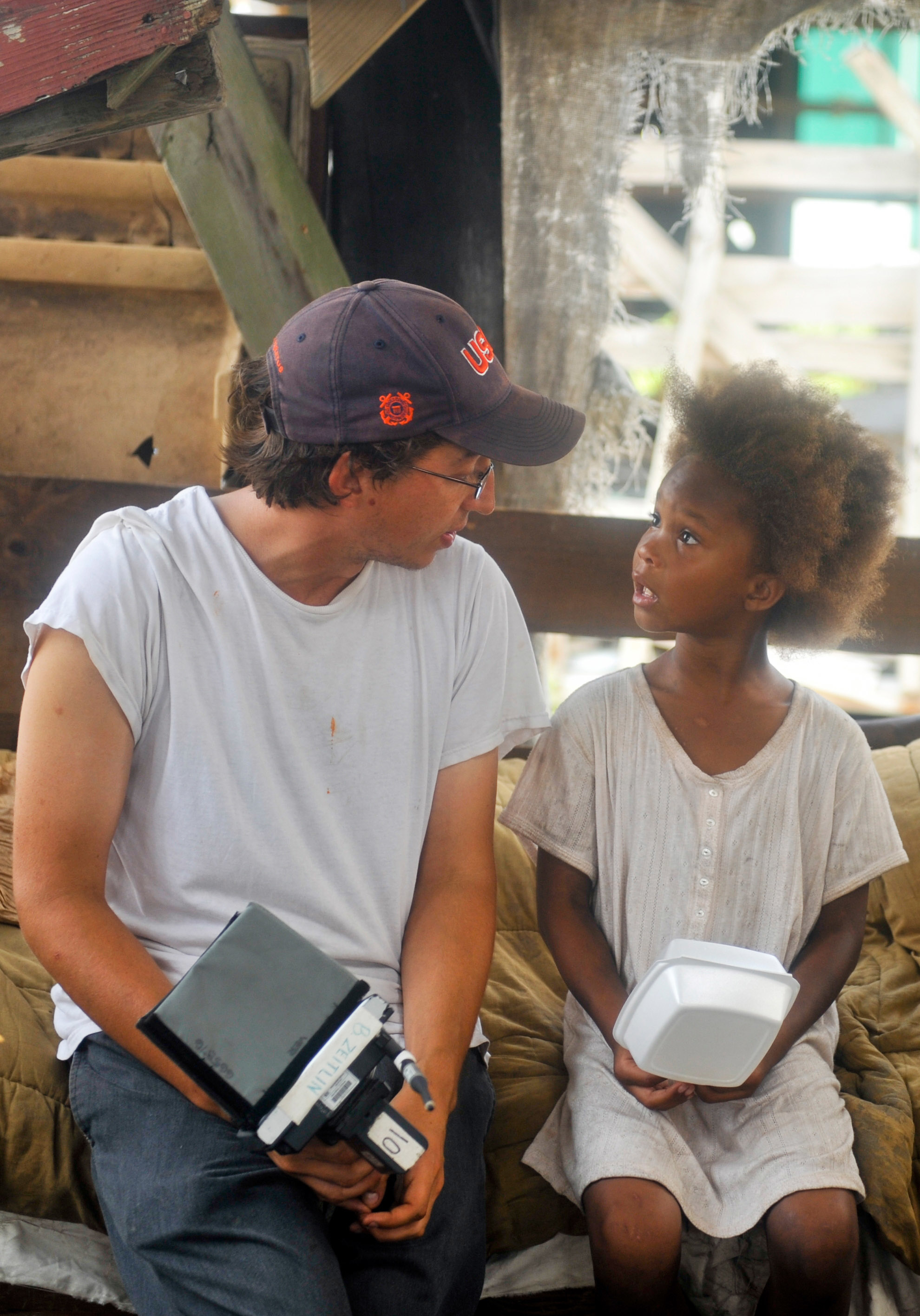 Director Benh Zeitlin sitting and talking to Quvenzhané Wallis on set