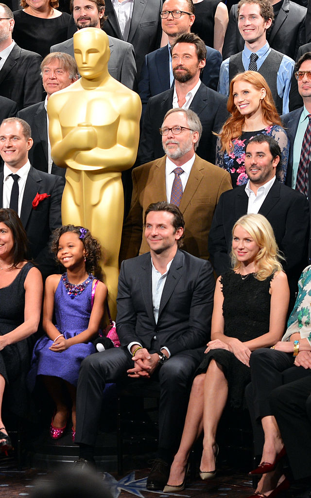 Quvenzhané Wallis sits next to Bradley Cooper during the class photo for the 2013 Oscar nominees
