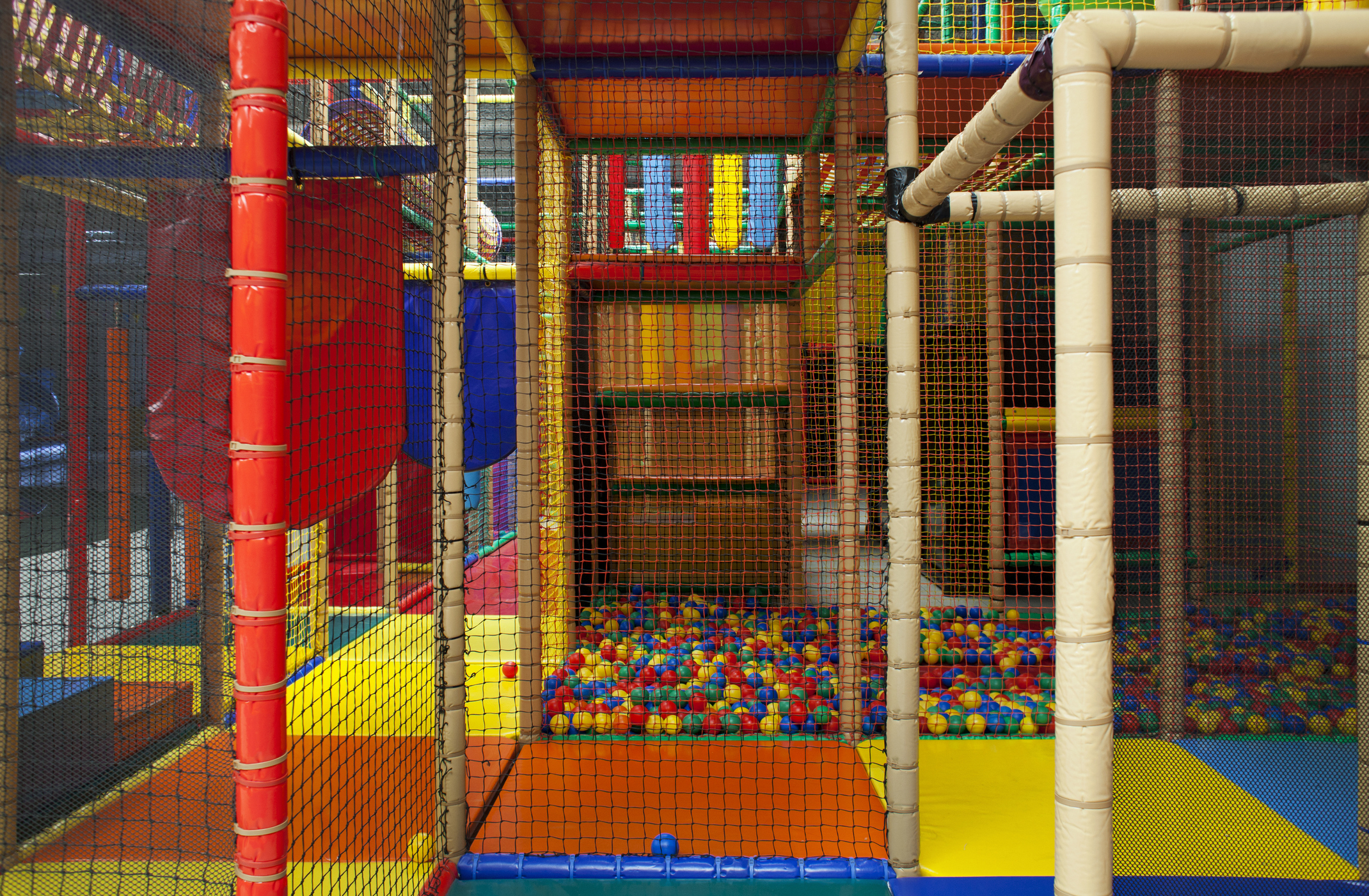 Indoor playground with climbing structures and ball pit