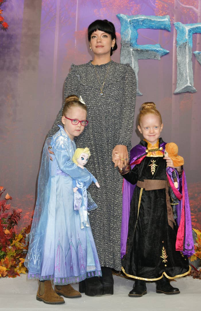 Lily  with her two children dressed as Frozen characters, Elsa and Anna, at a themed event