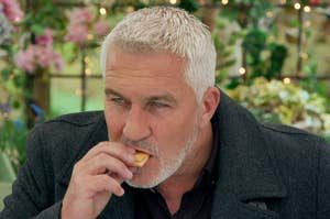 Paul Hollywood eating a cookie on The Great British Baking Show
