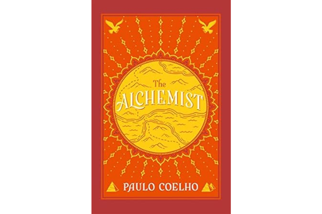 Book cover of &#x27;The Alchemist&#x27; by Paulo Coelho with title and author&#x27;s name