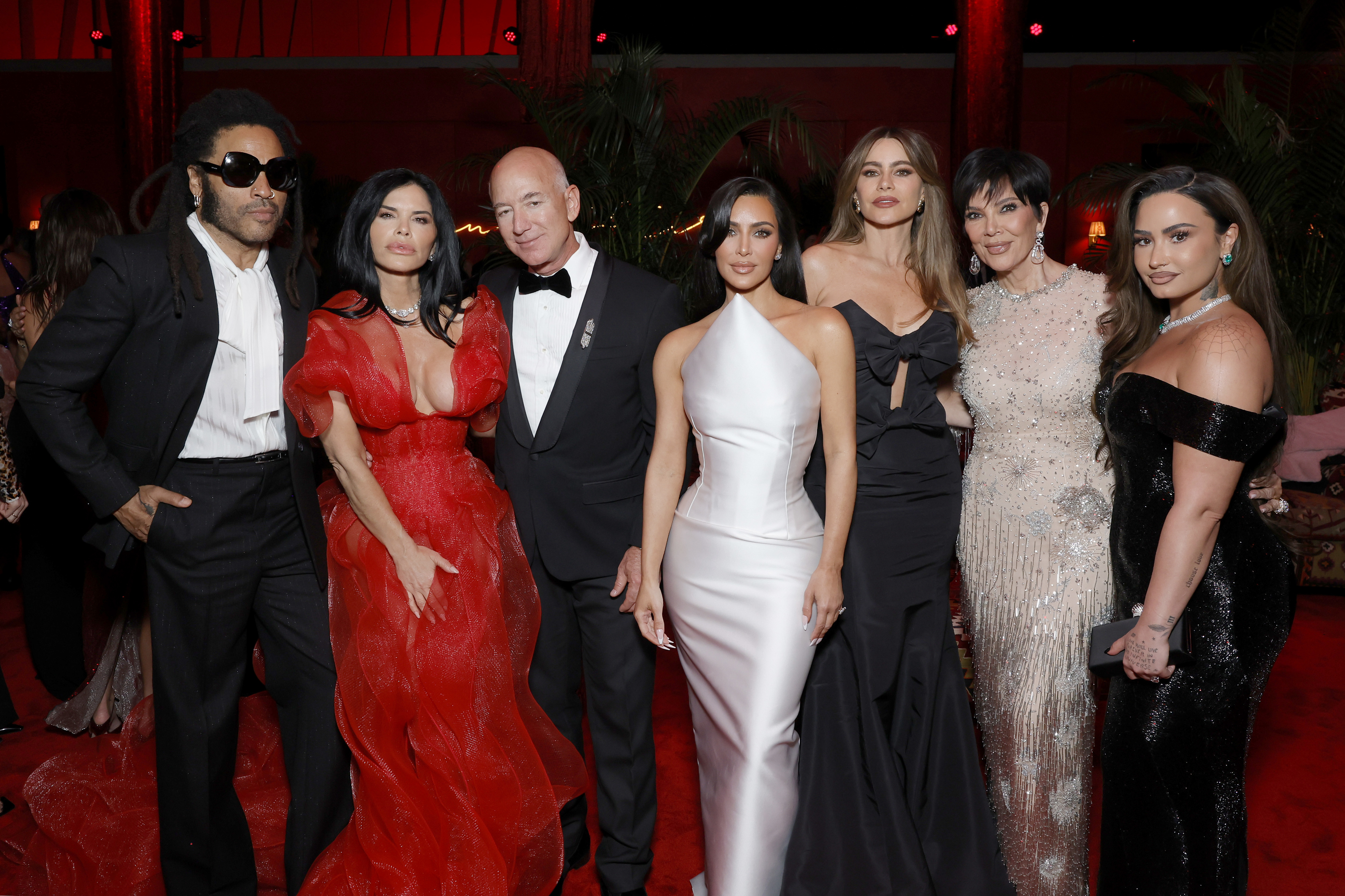 Kim at the after party posing for a photo with Lenny Kravitz, Lauren Sanchez, Jeff Bezos, Sofía Vergara, Kris Jenner, and Demi Lovato