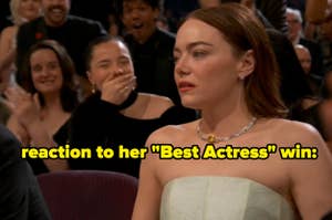 Actress in a strapless dress reacts to winning an award, audience applauding in background