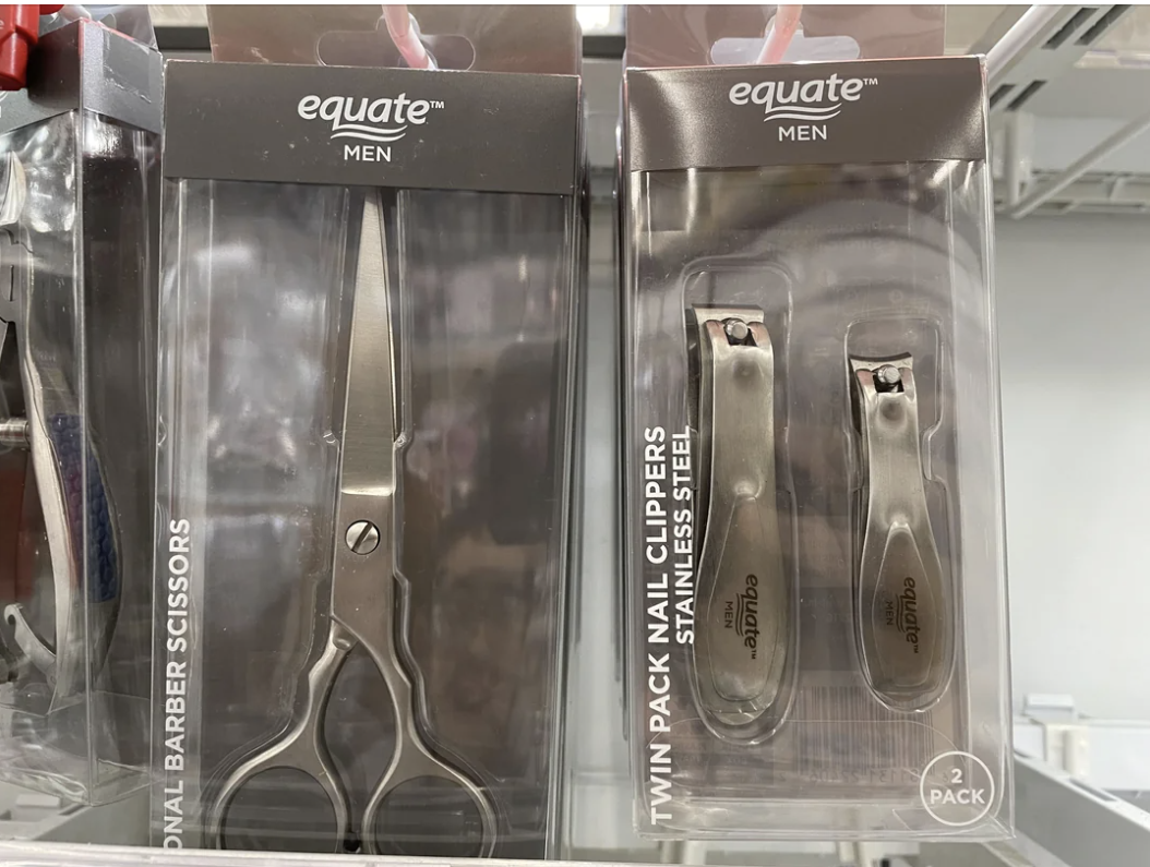 Two Equate Men&#x27;s grooming products on a shelf: barber scissors and nail clippers set