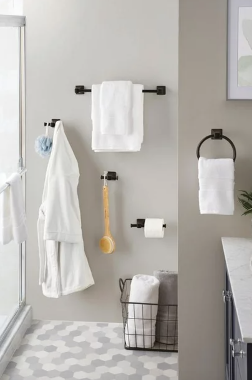 Five-piece black steel bathroom hardware set with towels on wall