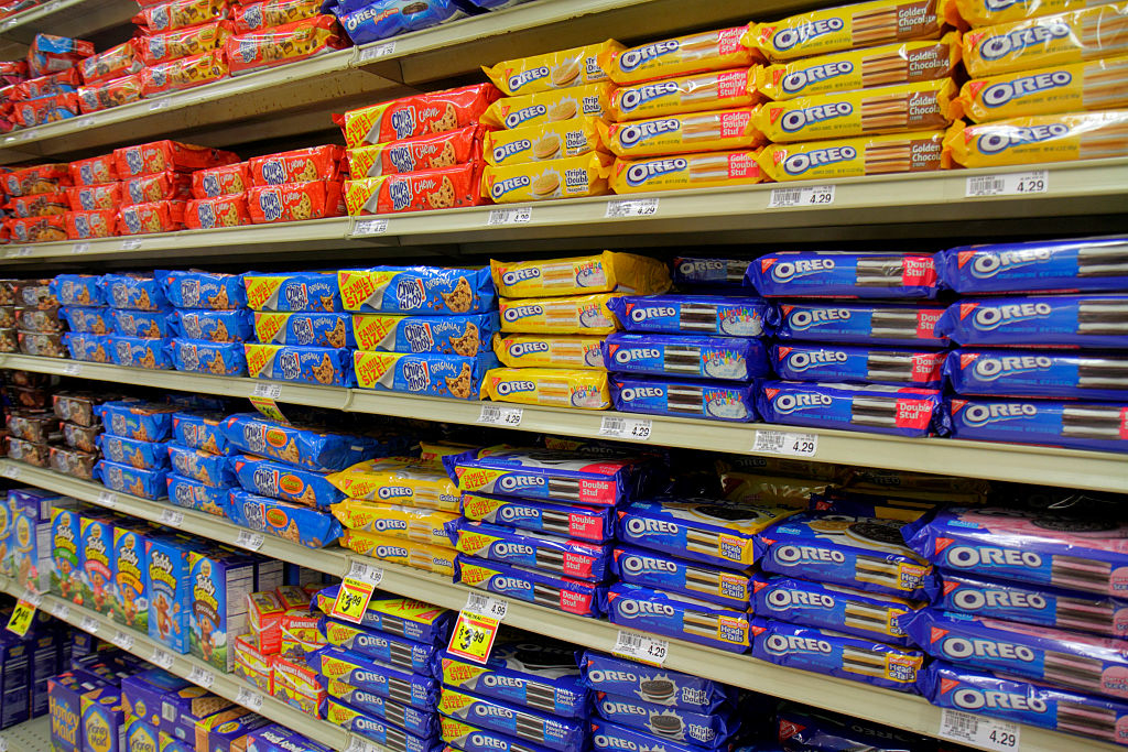 Aisle in a store with shelves stocked with various Oreo cookie packages