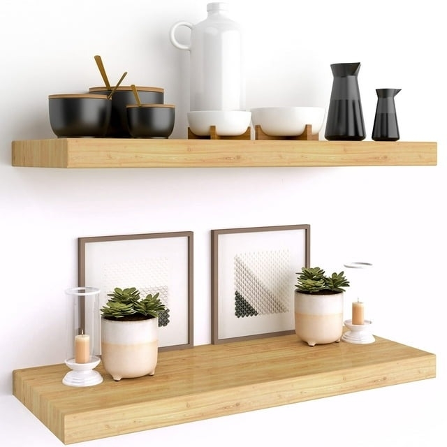 Light brown wood floating shelves with neatly arranged cookware and plants