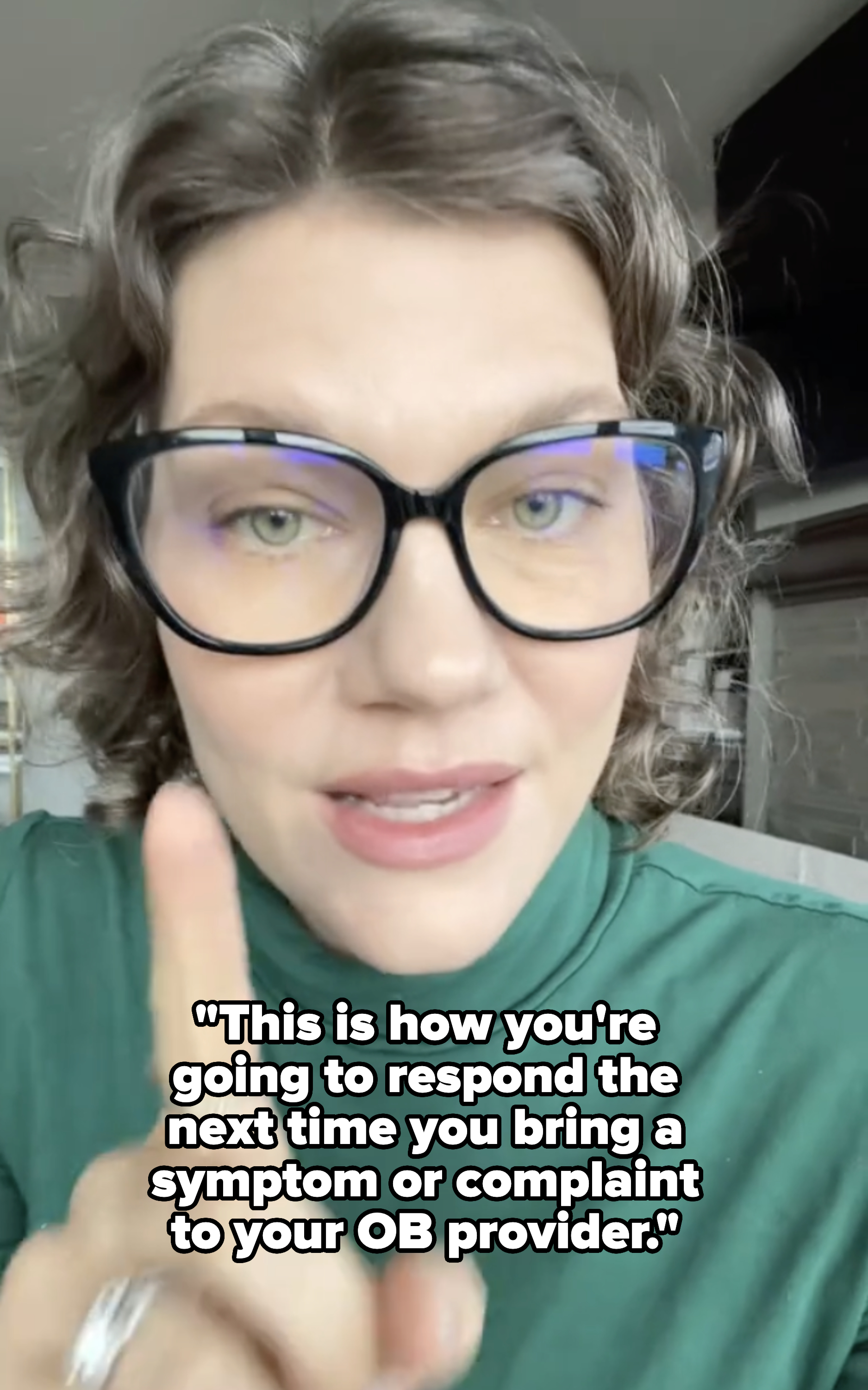 Woman with glasses raising a finger, wearing a turtleneck top with a ring on the finger, with caption about how to respond to &quot;your OB provider&quot;