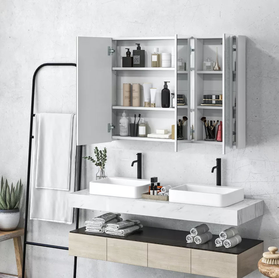 A modern bathroom vanity with double sinks, wall-mounted mirror cabinet open showing shelves with toiletries, and towel on a ladder rack