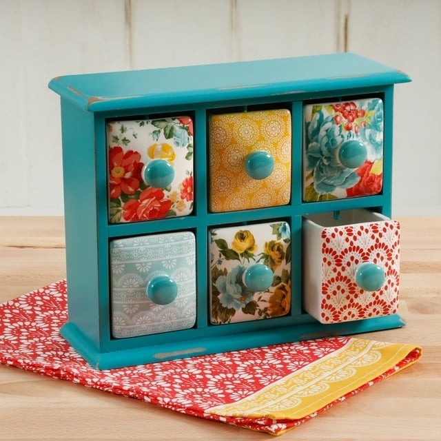 the spice and tea organizer with six drawers on a countertop